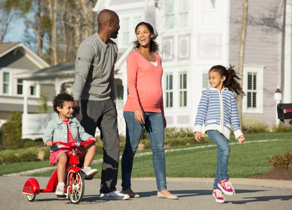 Family walking through suburban neighborhood .width .jpg