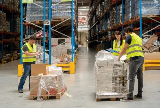warehouse employees unpacking boxes.width .jpg