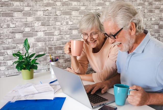 senior couple laptop smiling gettyimages