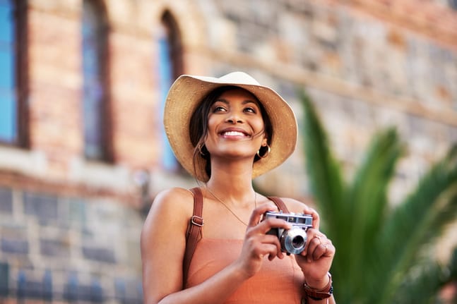 woman s smiling holding a camera gettyimages