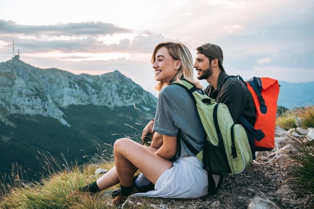 man and woman hikers on mountaintop.width .jpg