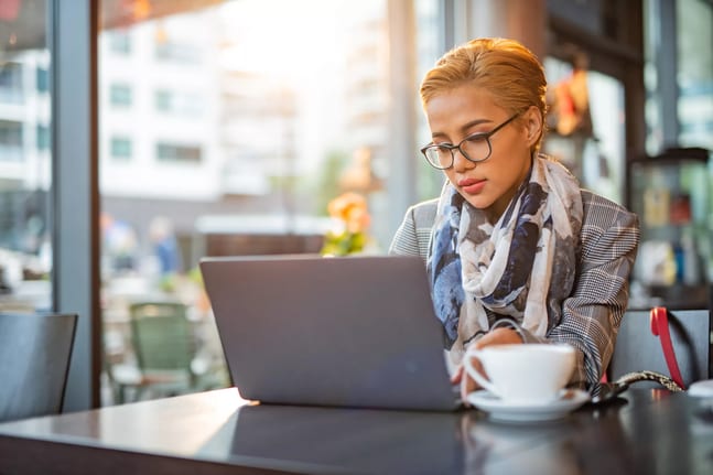 woman s laptop serious at coffee bar gettyimages .jpg