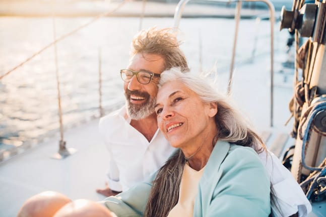 mature couple sitting on a boat smiling.jpg