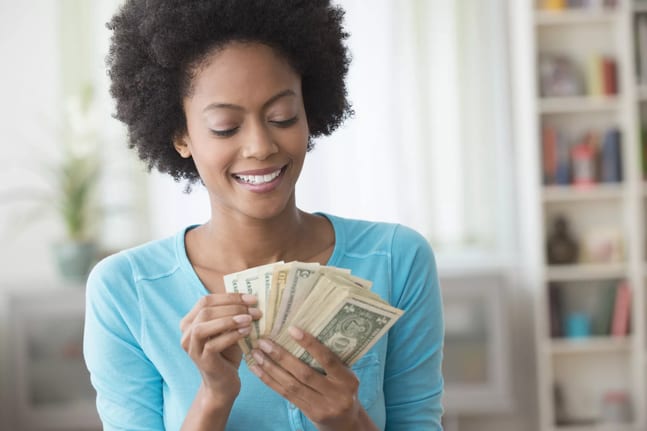 smiling person counting money.jpg