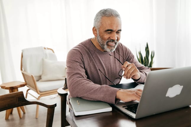 older man smiling laptop gettyimages .jpg