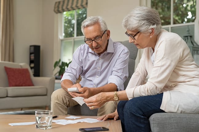 retired couple looking at financial paperwork.jpg