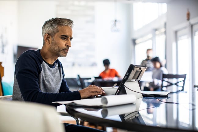 person looking intently at laptop screen RtKWA