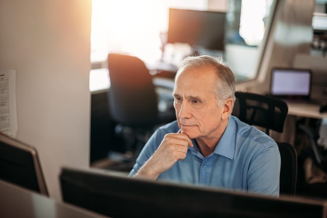 older man serious expression at computer gettyimages fzoFI