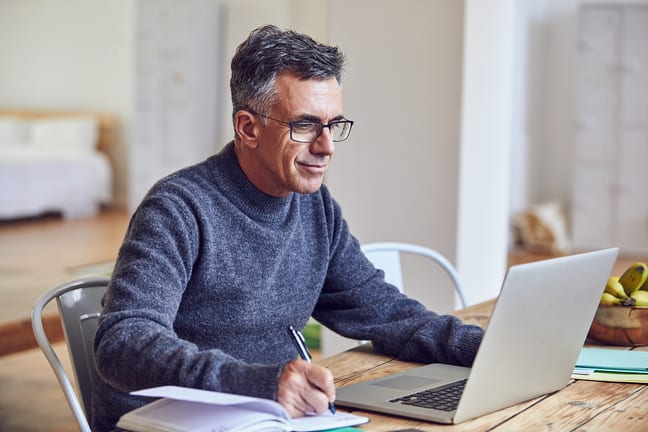middle aged man notes laptopgettyimages