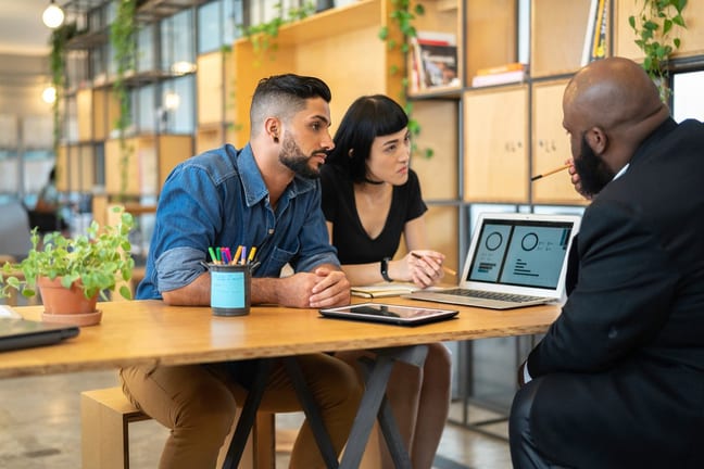 Couple meeting with banker in an office QDQ.width