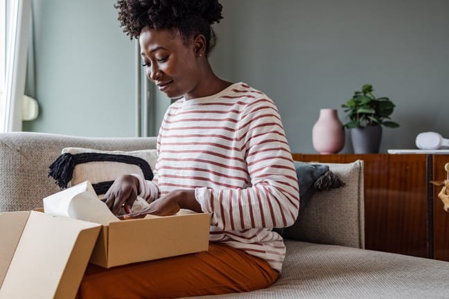 Woman packing up box to return item. juBzvHy.width