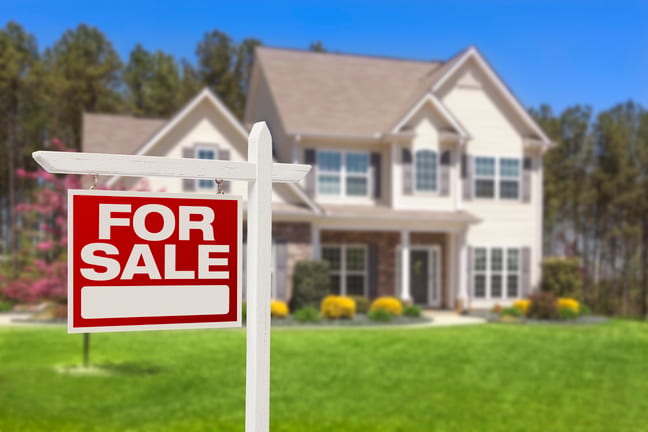 a house with a for sale sign in front gettyimages