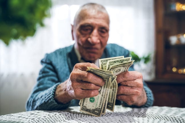 person holding one dollar bills