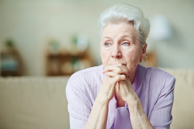 senior woman worried thinking with hands clasped in front of face.jpg