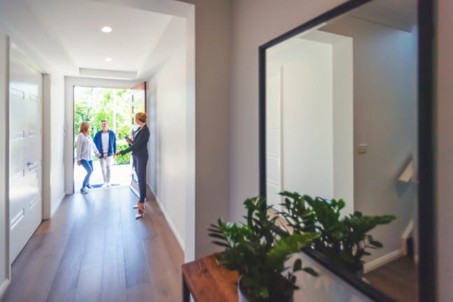 two people walking into house with realtor hd.width