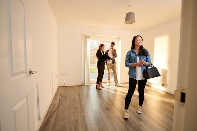 two people with realtor in empty house NVSf.width