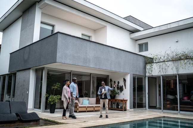 two people with realtor looking at pool rml.width