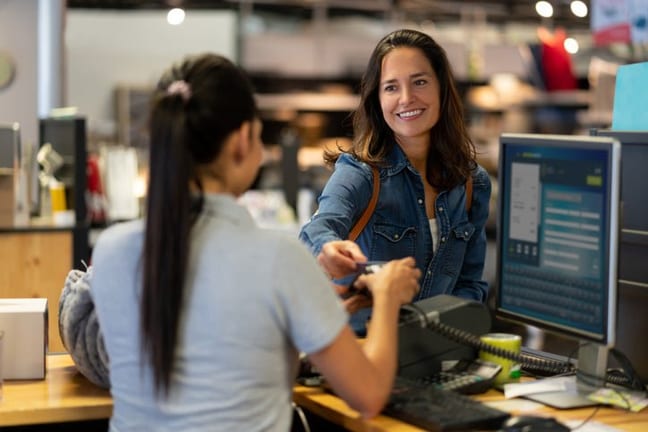 woman paying with credit card in department s.width tBfvJX