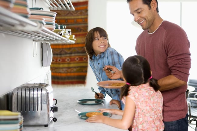 Father in kitchen with kids making breakfast .width .jpg