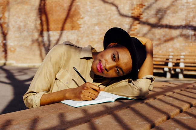 Woman in park writing in journal QsKsNb.width .jpg