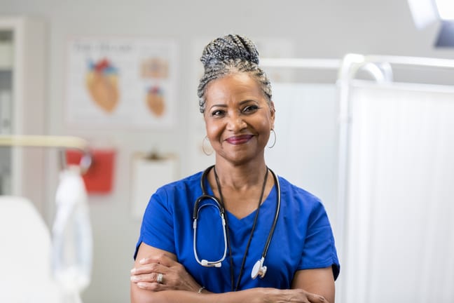 getty nurse smiling at camera with arms crossed healthcare.jpg