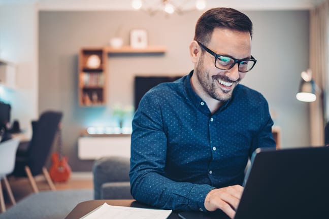 man s smiling laptop gettyimages .jpg