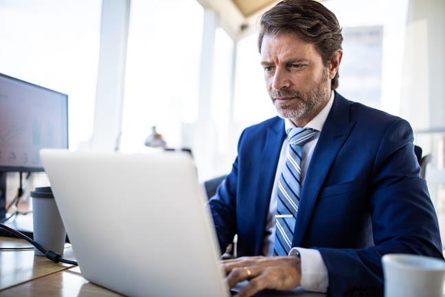 man middle aged business suit serious laptop gettyimages .jpg
