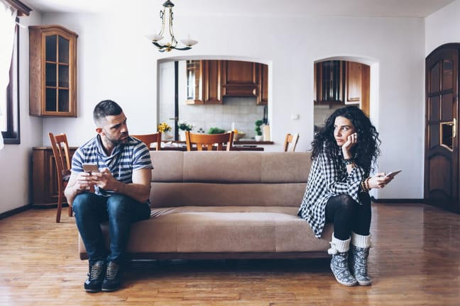 man and woman sitting at opposite ends of a c.width okzr.jpg