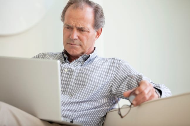 older man laptop serious expression looks unhappy gettyimages .jpg