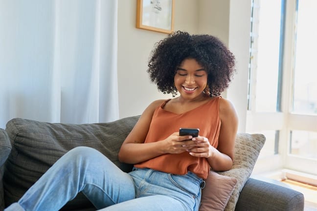 person on couch with phone TIHLN.width .jpg
