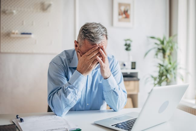 senior man laptop covering face gettyimages .jpg