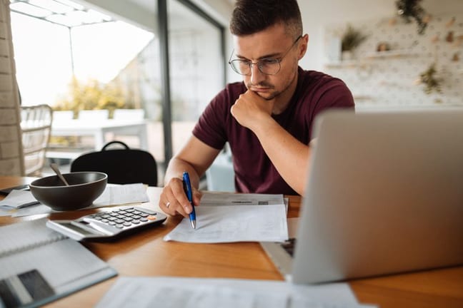 stressed man with bills and laptop.width .jpg