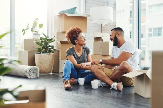 two people on floor between moving boxes kVBB.width .jpg