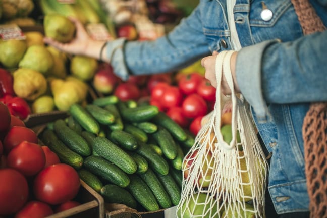 woman buying produce at grocery store.width .jpg