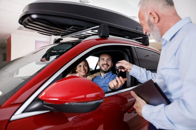 Couple receiving a new car keys from car sale.width PKhkAs.jpg