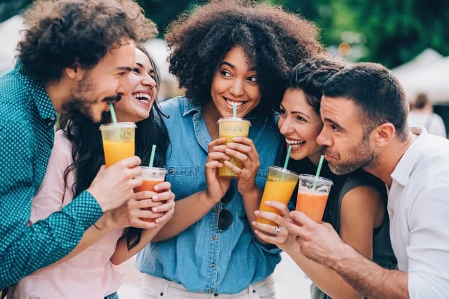 Group of friends drinking juice outdoors. xRC.width .jpg