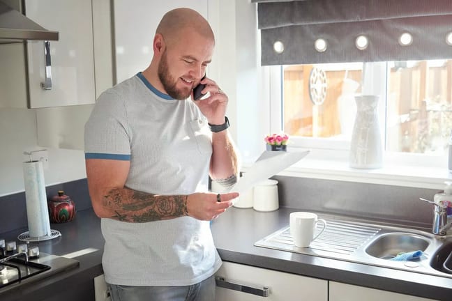 Homeowner on phone with mortgage company pFR.width .jpg