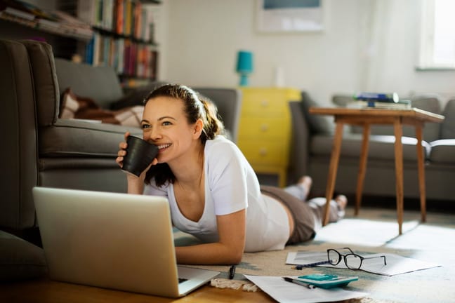 Woman pauses paying bills to enjoy coffee k.width .jpg
