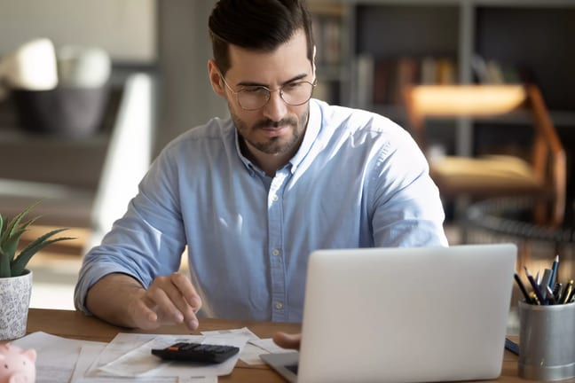 a person with a laptop calculator and documents in front of them gettyimages .jpg