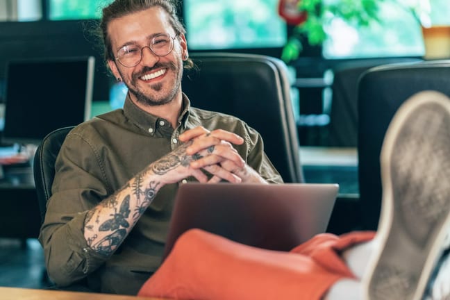 getty happy feet on desk smiling tattoos.jpg