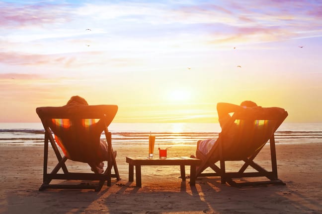 mature couple relaxing on beach at sunset.jpeg