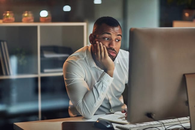 person sitting at a computer looking uncertain.jpg