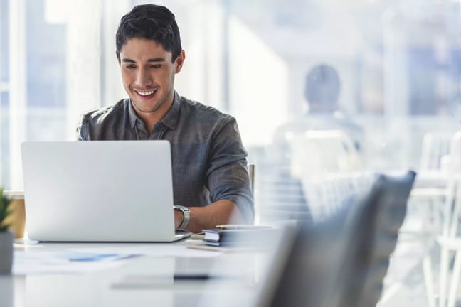 young man s a smiling person at a laptop gettyimages .jpg