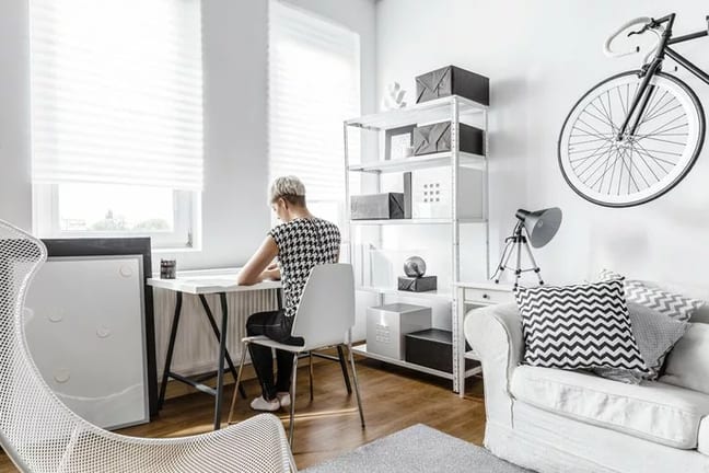 young woman at desk in small apartment.width .jpg