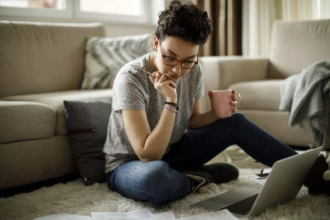 young woman on floor with laptop FoAMBbr.width .jpg