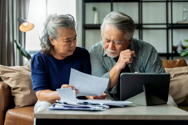 people with concerned expressions looking at document.jpg