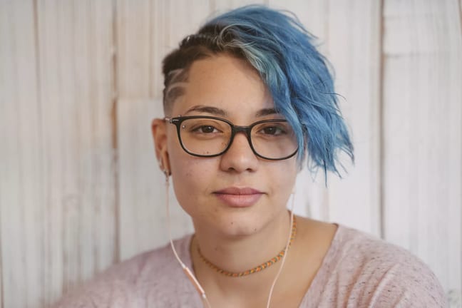 getty blue hair slight smile serious millennial.jpg