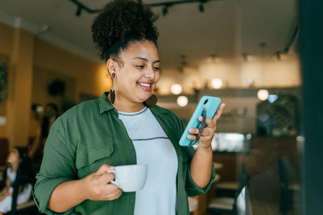 getty happy looking at phone smiling success winning.jpg
