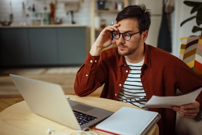 man s laptop holding head gettyimages .jpg