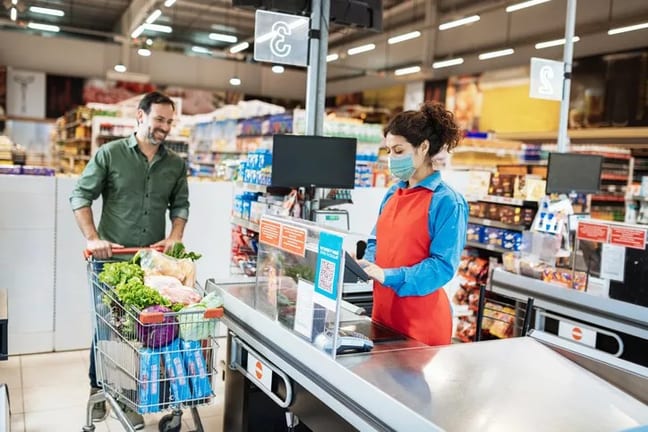 man with grocery cart at cashier.width .jpg